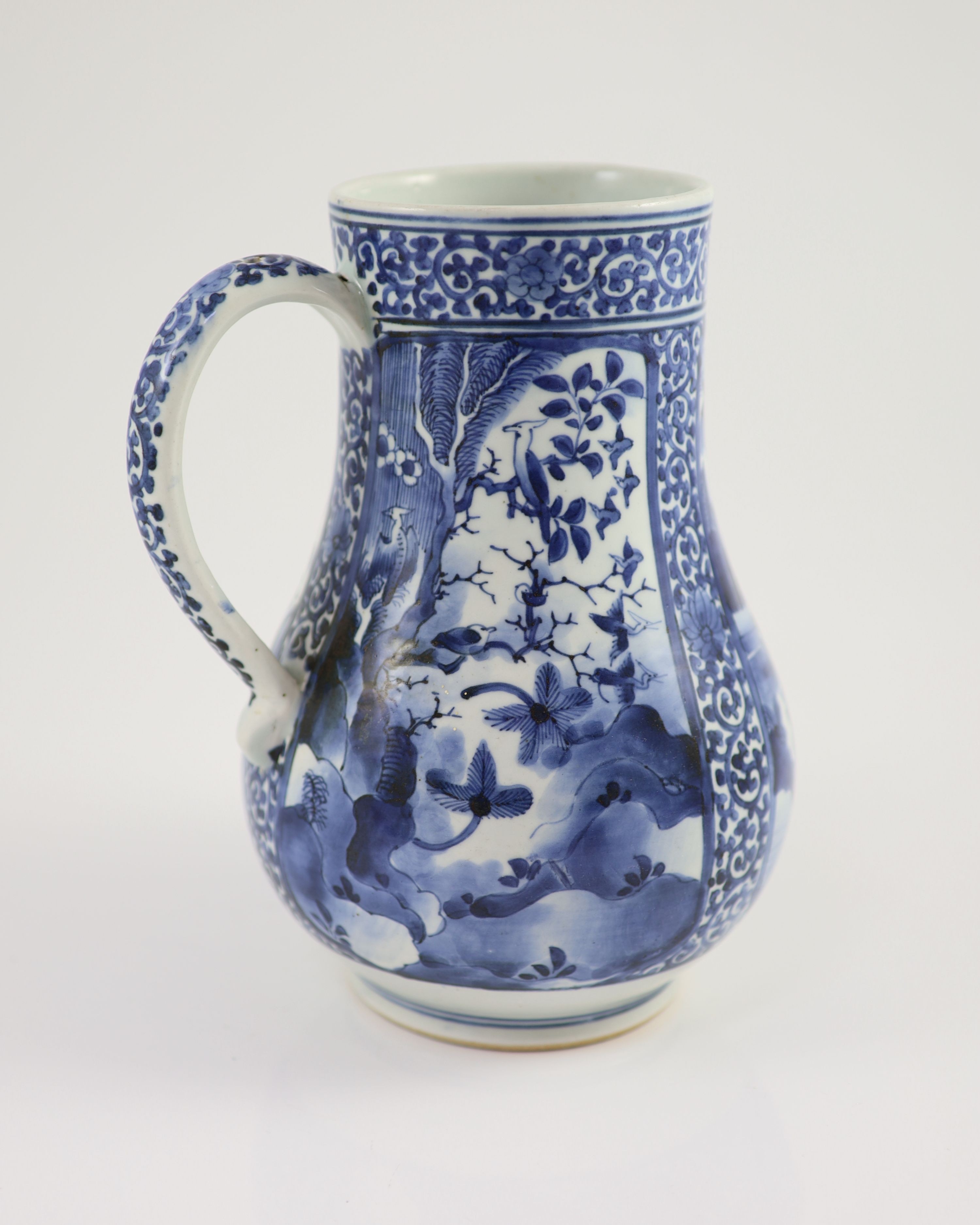A Japanese Arita blue and white tankard, c.1700, 23.8 cm high